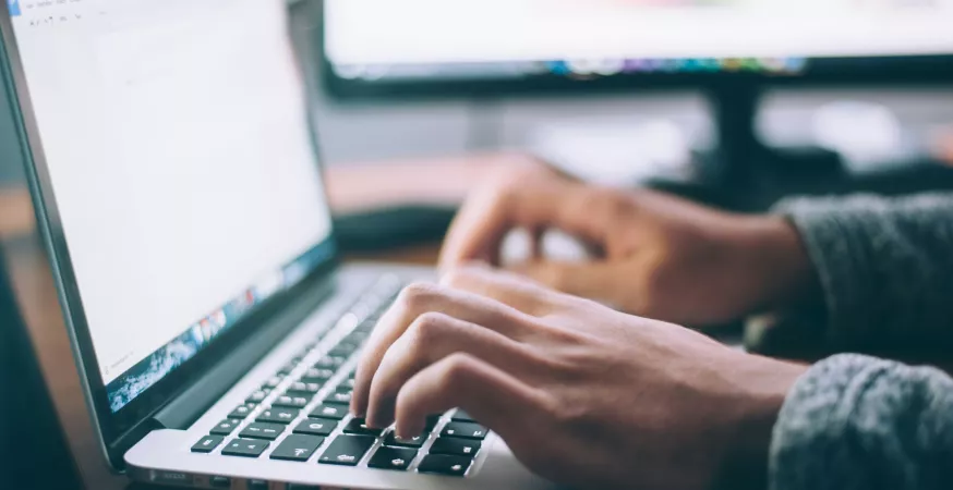 Un usager saisit du texte sur un clavier d'ordinateur